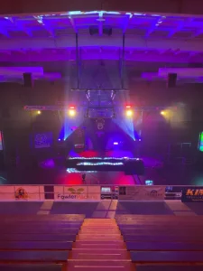 A stage with lights and a basketball hoop.