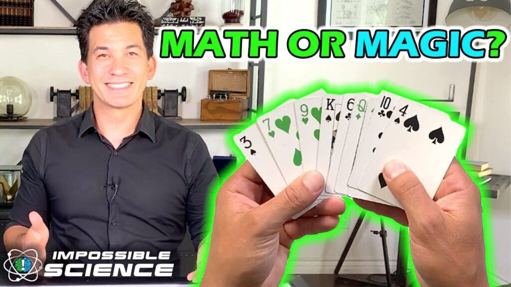 A man holding up playing cards in front of him.