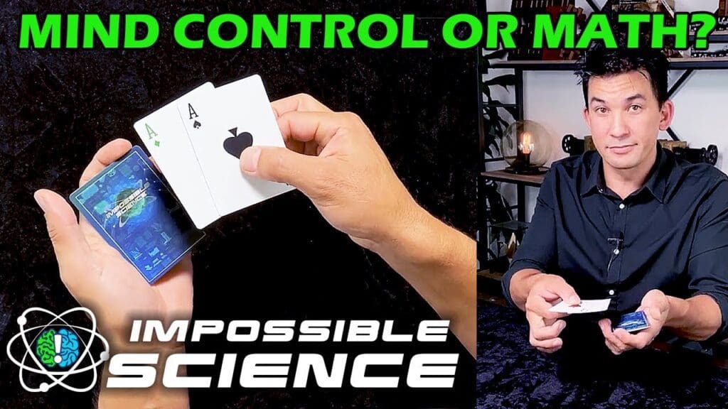 A man holding cards in front of him and another person holding a controller.